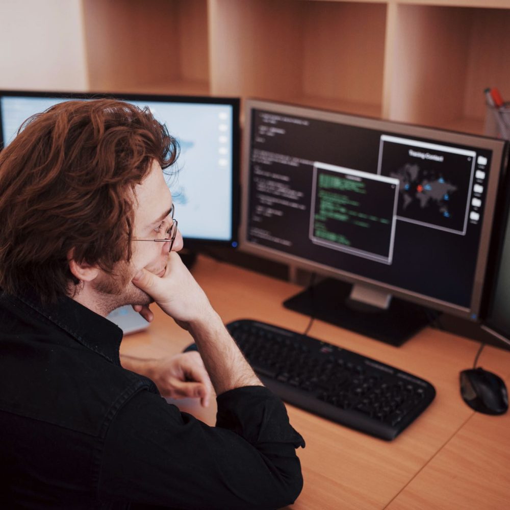 male-programmer-working-on-desktop-computer-with-m-93A5TRN.jpg